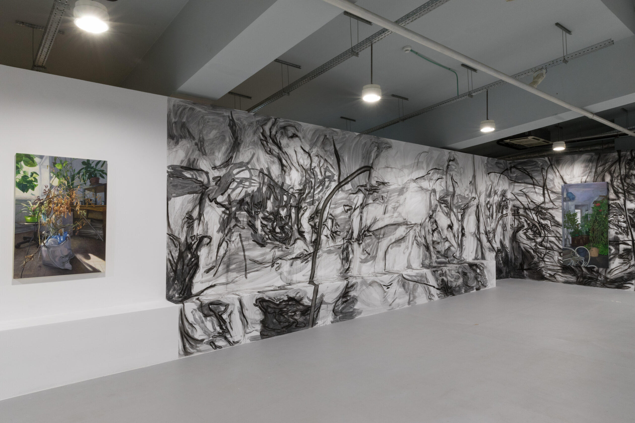 Mână stângă spre priveliște depărtată, expoziție personală de Ana Maria Micu, curatoare Simona Vilău, vedere cu instalația a două picturi în relație cu un desen mural